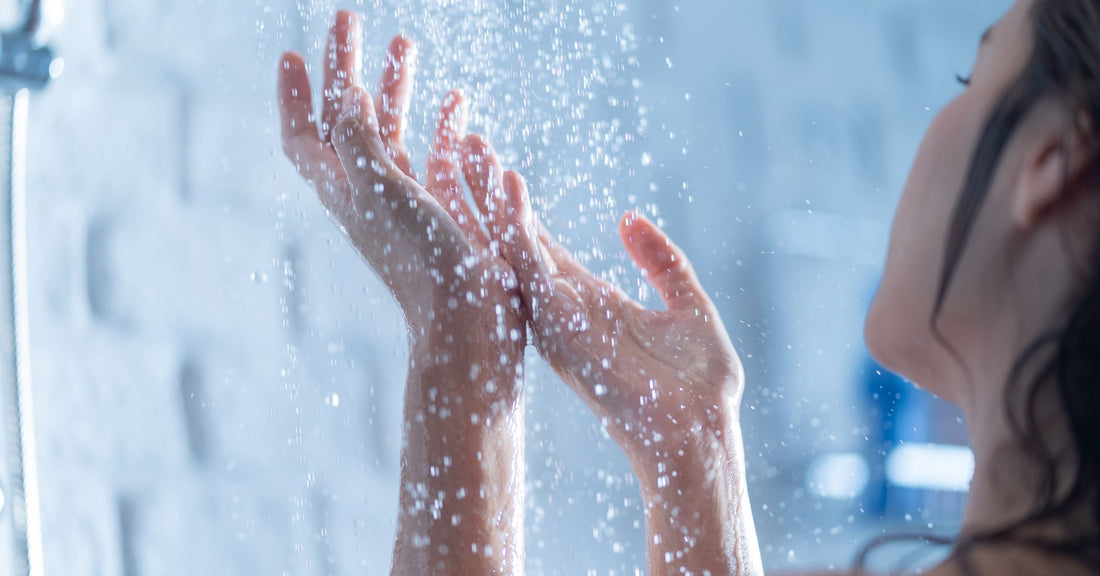 A woman showering under a clean and limescale free shower
